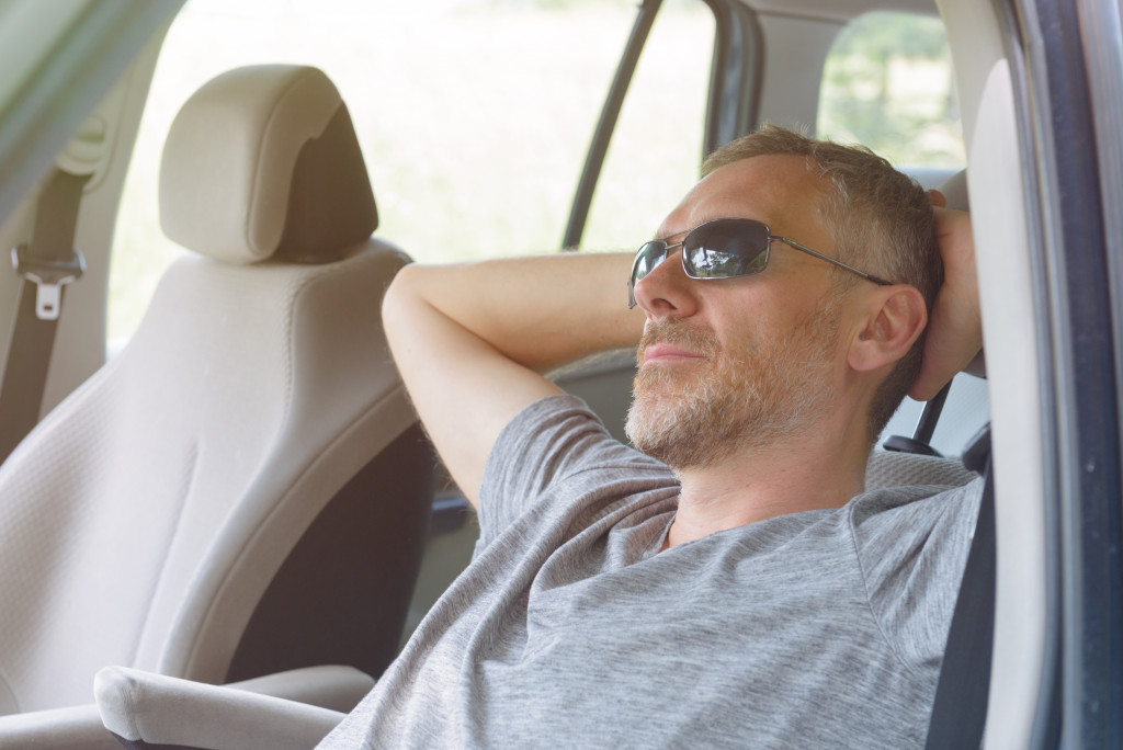 man relaxing in his car