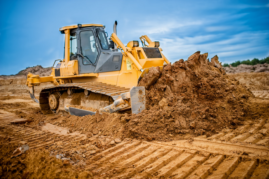Excavator working with sand in sandpit
