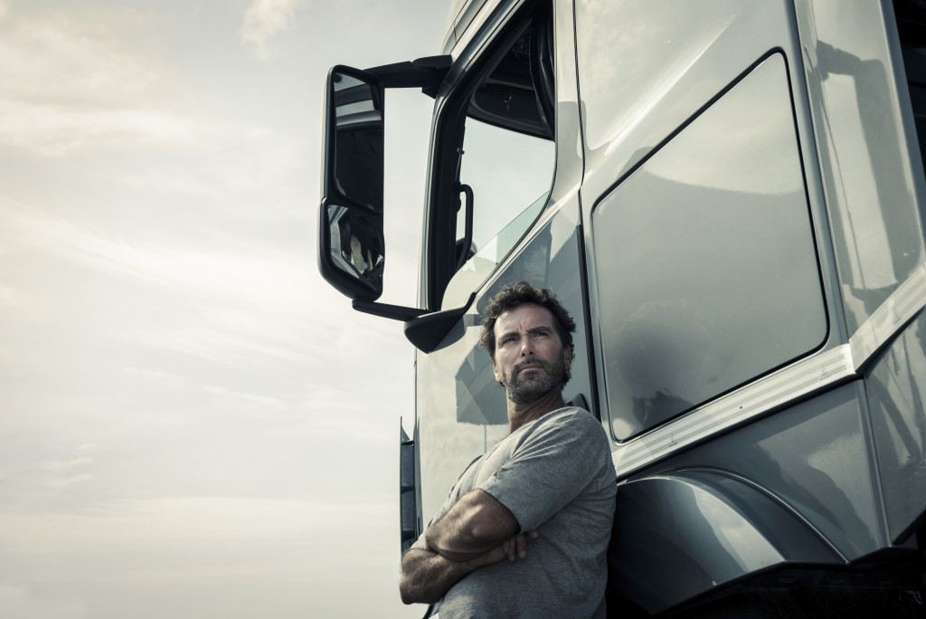 man standing in a truck door